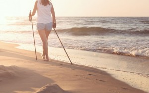 Close up of female nordic walking on a beach